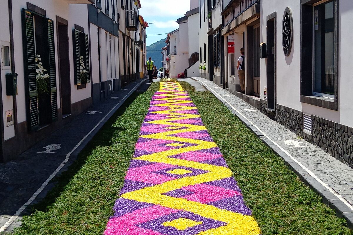 long colorful flower carpet decorating a narrow street in São Miguel Azores during a traditional festival