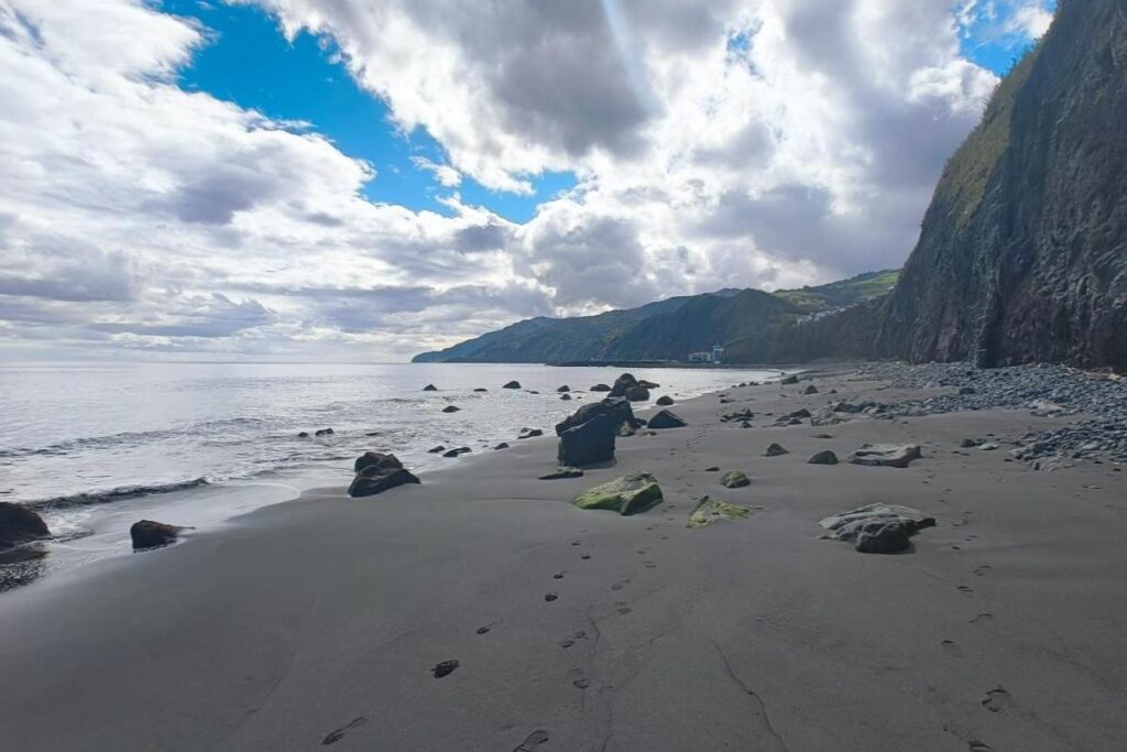 Praia do Morro volcanic black sand beach with blue sky in Povoação São Miguel Azores